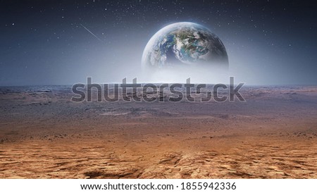 Earth planet in the sky over desert and stones. View on planet from Mars surface. Abstract sci-fi wallpaper. Elements of this image furnished by NASA