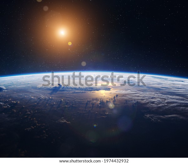 Earth planet surface in\
outer space with stars. Sun and stars. Space wallpaper. Horizon\
with clouds, blue sky and ocean. Elements of this image furnished\
by NASA