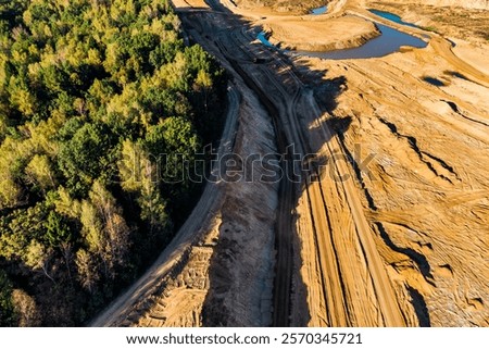Earth razed to the forest during the development of a sand quarry, view from above