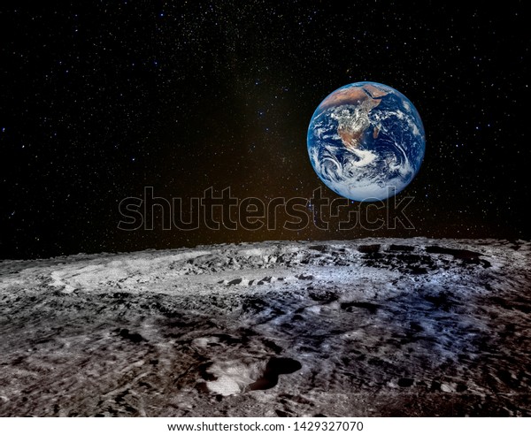 Earth rises above lunar horizon. Elements of this\
image furnished by NASA.