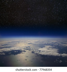 The Earth In Space. High Altitude View Of The Surface Against The Starry Night Sky.