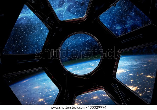 Earth and star in spaceship window\
porthole. Elements of this image furnished by\
NASA