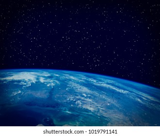 Earth and stars. The elements of this image furnished by NASA. - Shutterstock ID 1019791141