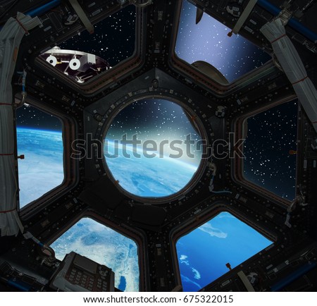 Earth sunrise view through the window of a space ship. 