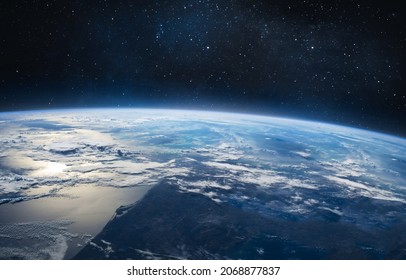 Earth Surface With Blue Sky And Clouds. Blue Planet And Deep Space With Stars. Elements Of This Image Furnished By NASA