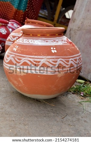 Earthen pots kept in series usually come less in heat. black background. selective focus