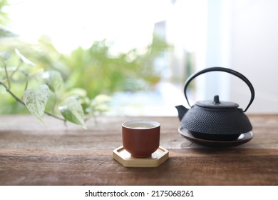 Earthenware Tea Cup And Tea Pot On Wooden Table Outdoor Relaxation Drinking