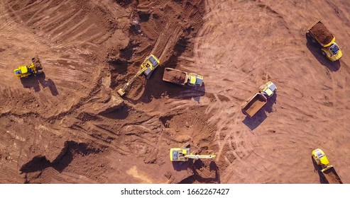 Earthmoving equipment. Aerial view of large construction site with several earthmover machines. - Powered by Shutterstock