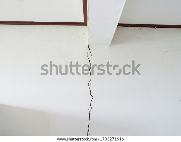 Earthquake damaged to the walls of the home.\
Cracked wall from earthquake\
damage.