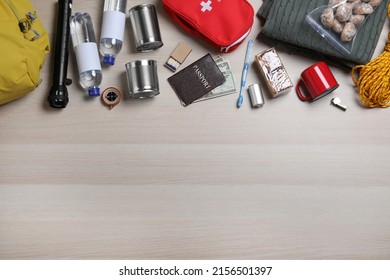 Earthquake Supply Kit On Wooden Table, Flat Lay. Space For Text