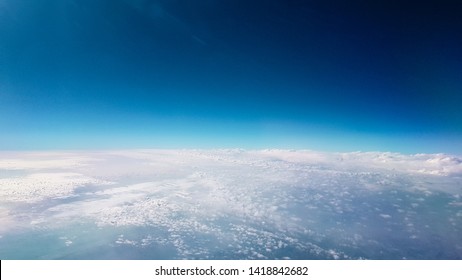 Earth's Curvature And Horizon Glowing In Dark Space