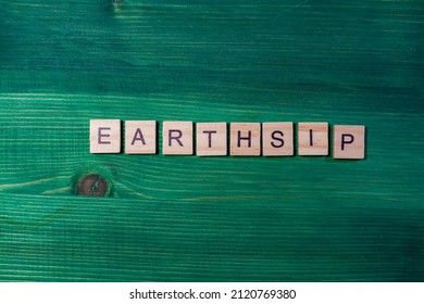 Earthship Letters On Wooden Background