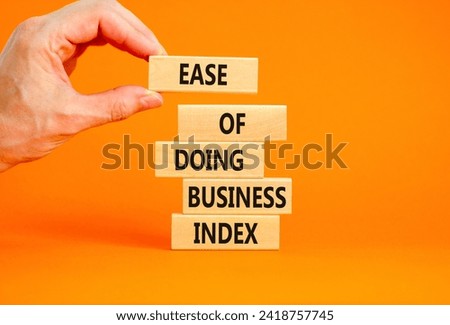 Ease of doing business index symbol. Concept words Ease of doing business index on wooden blocks. Beautiful orange table orange background. Business, ease of doing business index concept. Copy space.