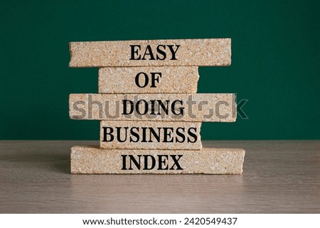 Ease of doing business index symbol. Concept words Ease of doing business index on brick blocks. Beautiful wooden table green background. Business, ease of doing business index concept. Copy space.