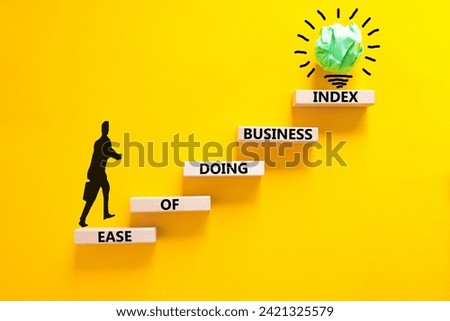 Ease of doing business index symbol. Concept words Ease of doing business index on wooden blocks. Beautiful yellow table yellow background. Business, ease of doing business index concept. Copy space.