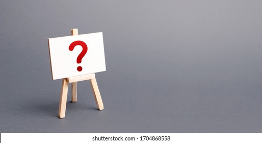 Easel with a question mark. Curiosity, mystery, investigation research. Poll Survey. Announcement of upcoming event, surprise. Unknown. Instability and uncertainty. No reaction or prognosis. - Shutterstock ID 1704868558