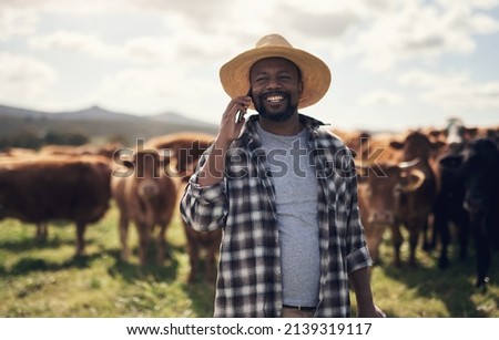 The easiest way to connect with a wider agricultural community. Shot of a mature man using a smartphone while working on a cow farm.