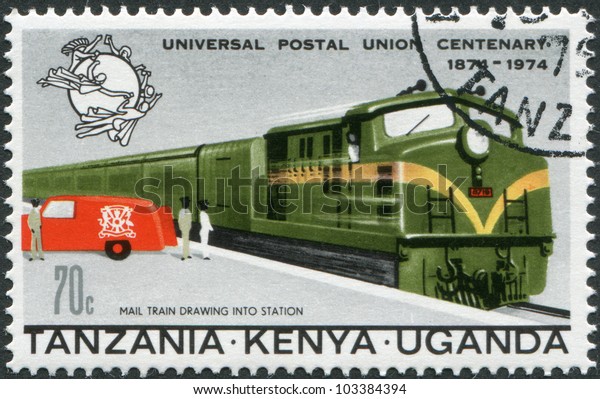 EAST AFRICAN COMMUNITY - CIRCA 1974: A stamp printed\
in East African Community, is dedicated to the 100th anniversary of\
the Universal Postal Union, shows a mail train and postal car,\
circa 1974