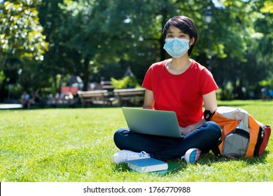 East Asian Male Student With Face Mask At Campus Of University In Summer