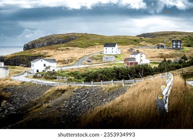 East Coast Scene of traditional homes overlooking high rocky cliffs and the Atlantic Ocean new Elliston Newfoundland Canada