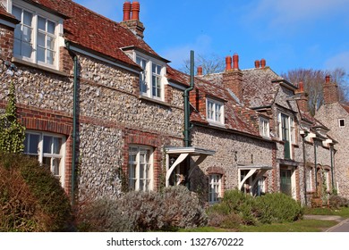East Dean, East Sussex, England, U.K. - 02/20/2019. These beautiful old cottages with their flint walls and red tiled roofs border the village green. 