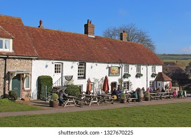 East Dean, East Sussex, England, U.K. - 02/20/2019. A view of the Tiger Inn from the village green of East Dean. This fifteenth century picturesque pub is a favourite tourist destination.