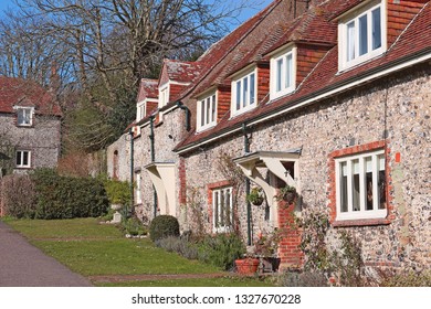 East Dean, East Sussex, England, U.K. - 02/20/2019. These beautiful old cottages with their flint walls and red tiled roofs border the village green. 
