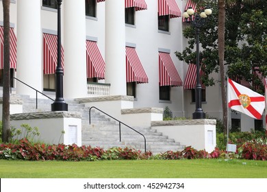 East entrance of State of Florida Historic Capitol building. Red and white striped awnings at the front. The building is a symbol of Florida government and politics. 