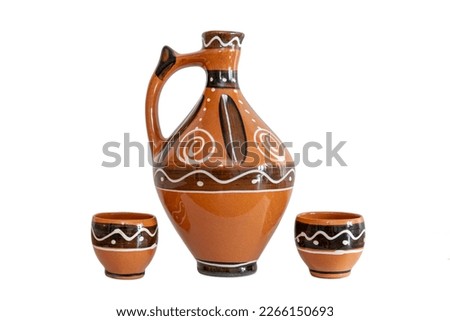 East european pitcher jug with glasses for alcohol beverages. Moldova, Romania, Ukraine, Baltic Countries folklore traditional pots.