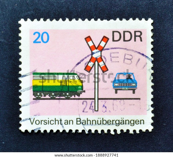 East Germany - circa 1969 :\
Cancelled postage stamp printed by East Germany, that shows Rail\
road crossing, with Locomotive, car and rail sign, circa\
1969.