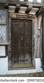 East Grinstead, West Sussex, UK, May 2018 - Front view of an ancient wooden door in East Grinstead, East Sussex, UK