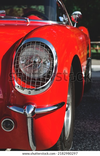 East Gwillimbury, Ontario, Canada - May 28, 2022:\
Closeup front bumper and headlight of the vintage retro red\
Chevrolet Corvette car