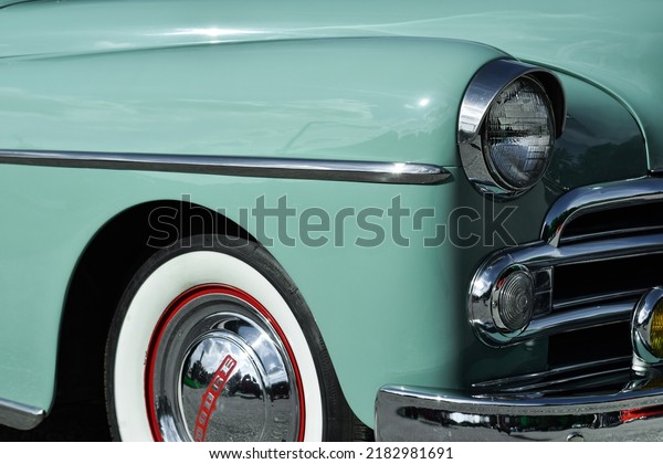 East Gwillimbury, Ontario, Canada - May 28, 2022:\
Closeup front bumper and headlight of the vintage retro mint green\
Dodge car