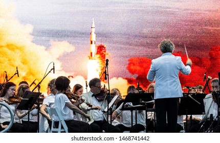 East Islip, NY, USA - 13 July 2019: The Long Island Concert Orchestra Performs For Free At Night, Under The Stars, At Heckshire State Park Honoring The 50th Anniversary Of Landing On The Moon.