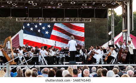 East Islip, NY, USA - 13 July 2019: The Long Island Concert Orchestra Performs For Free At Night, Under The Stars, At Heckshire State Park Honoring The 50th Anniversary Of Landing On The Moon.