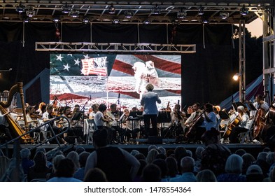 East Islip, NY, USA - 13 July 2019: The Long Island Concert Orchestra Performs For Free At Night, Under The Stars, At Heckshire State Park Honoring The 50th Anniversary Of Landing On The Moon.