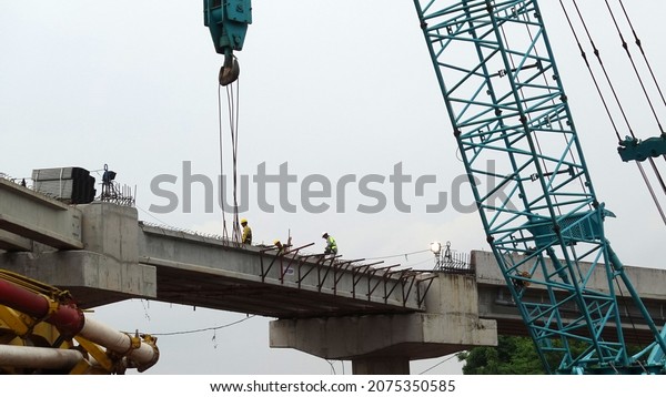 East Jakarta,\
Indonesia - 15, Nov, 2021: Construction of a flyover in front of\
the Bassura City\
Apartment.