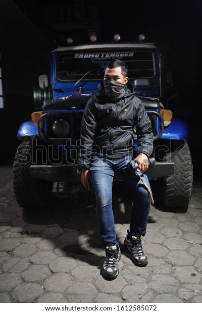 East Java, Indonesia - 19 Sept 2019:\
Random photographer taken a photos with a Land Cruiser jeep during\
night hour at Bromo Mountain, East Java,\
Indonesia