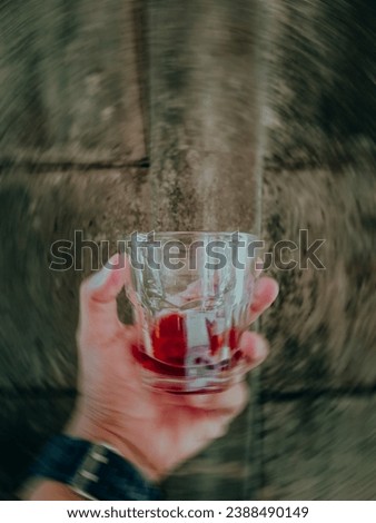 East Java, indonesia - December 9, 2022 : People who have finished drinking and feel unable to hold back the last sip