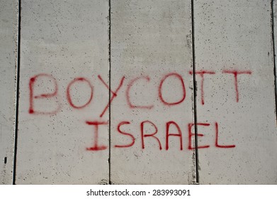 EAST JERUSALEM, OCCUPIED PALESTINIAN TERRITORIES - MARCH 26: Graffiti on the Israeli separation wall dividing the East Jerusalem neighborhood of Abu Dis reads, "Boycott Israel", March 26, 2012.