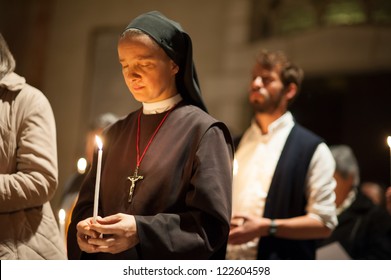 EAST JERUSALEM, PALESTINIAN TERRITORY - NOVEMBER 20: A Catholic nun holds a candle during a prayer service in the Basilica of St. Stephen, East Jerusalem, in solidarity with Gaza, November 20, 2012.