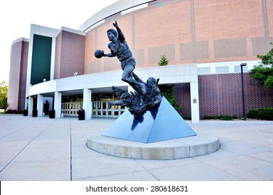 EAST LANSING, MI -22 MAY 2015- A statue of former Spartan basketball star Earvin Magic Johnson stands in front of the entrance to the Breslin Center at Michigan State University (MSU) in East Lansing.