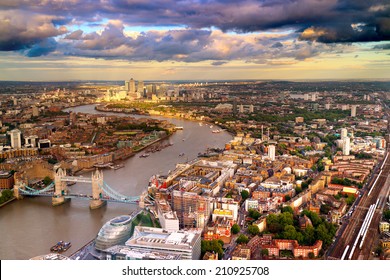 East London Skyline showing Tower Bridge,  Canary Wharf, City Hall and the Thames River. Taken during a cloudy sunset.