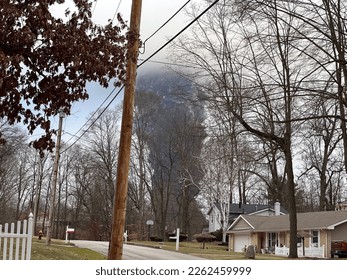 EAST PALESTINE  OH    Circa Feb 2023: The rising smoke cloud after authorities released chemicals from train derailment as seen from the ground in nearby neighborhood  Photo credit: RJ Bobin 