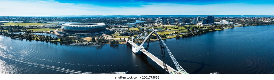 East Perth, Western Australia. Aerial panorama showing Matagarup Bridge pedestrian suspension bridge crossing the Swan River in Perth, and also Perth Stadium.