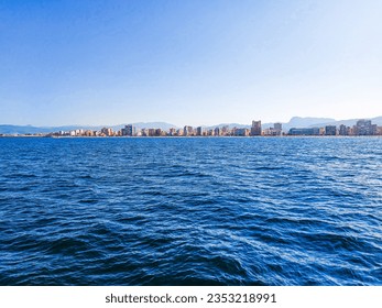 The east photo is taken from the view of Gandía beach. Very calm mediteranean sea with blue water.