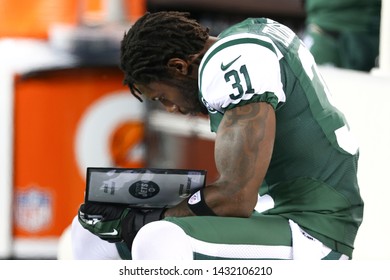 EAST RUTHERFORD, NJ - NOV 22: New York Jets Cornerback Antonio Cromartie (31) Reads A Playbook Against The New England Patriots At MetLife Stadium On November 22, 2012 In East Rutherford, New Jersey.