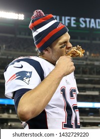 EAST RUTHERFORD, NJ - NOV 22: New England Patriots quarterback Tom Brady (12) takes a bite out of a turkey leg after the game against the New York Jets on November 22, 2012.