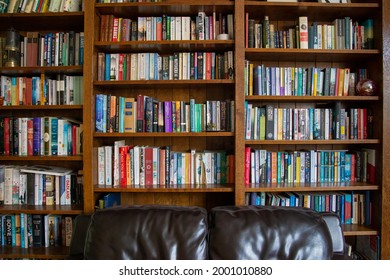 East Sussex, England - August 09 2020: Wooden bookcase filled with books in a UK home setting