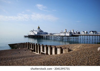 Eastbourne Seafront and Pier, East Sussex, England. A low angle view across the pebbles towards the Victorian pier.